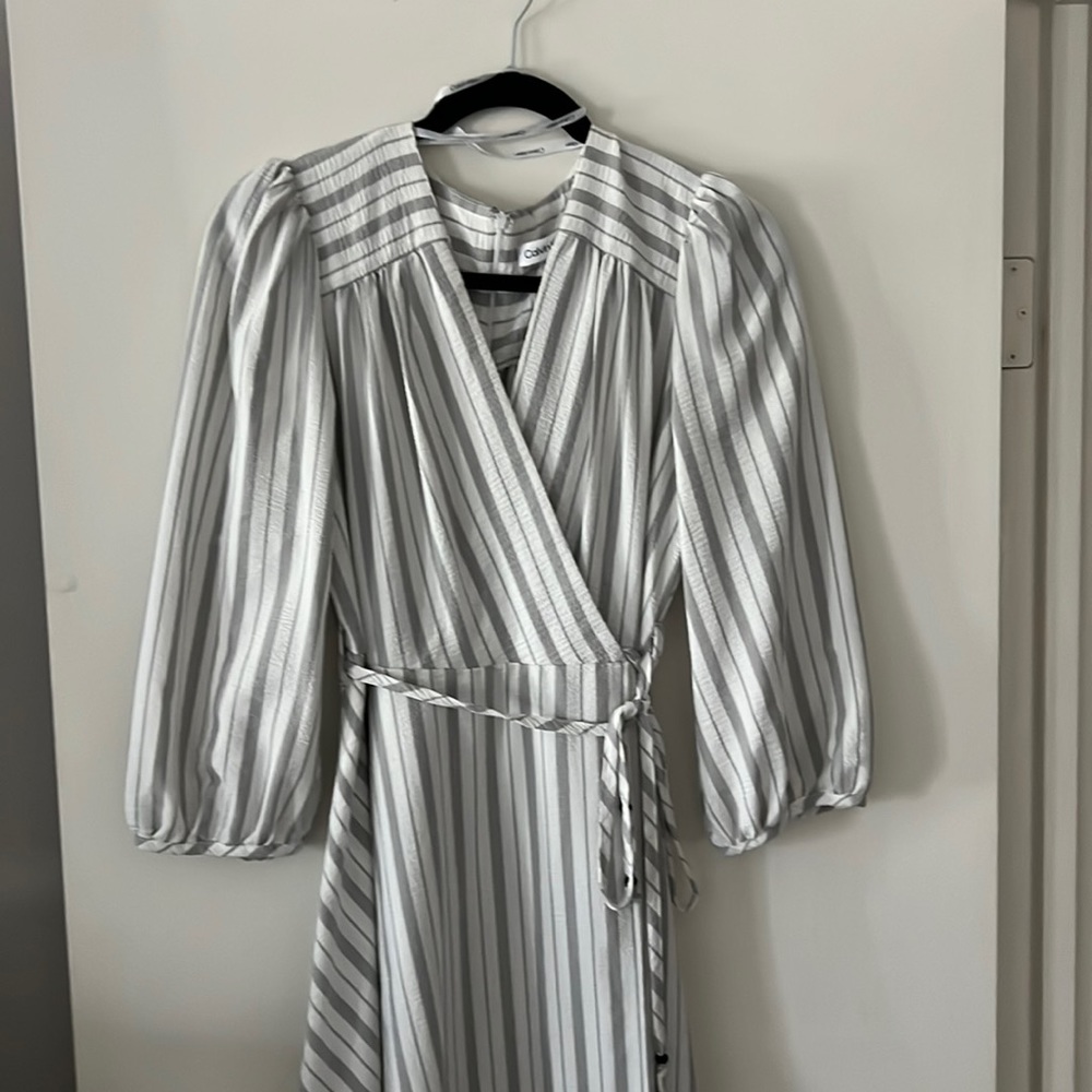 Women’s gray Striped peplum style dress.